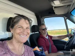 Tara and Andy in the cab of the rental truck, French farm fields rolling past the window on the long drive to Chablis.